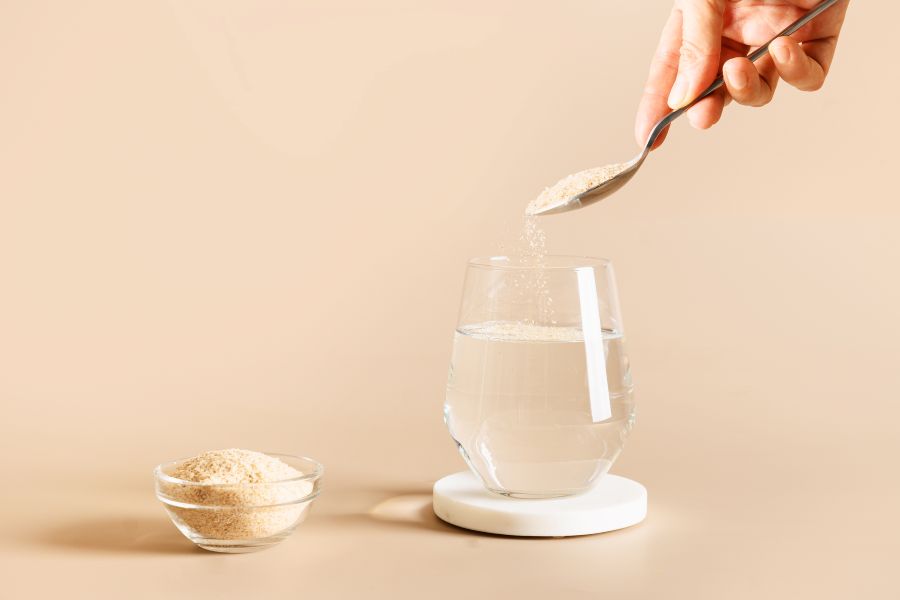 Woman adds fiber supplement to a glass of water